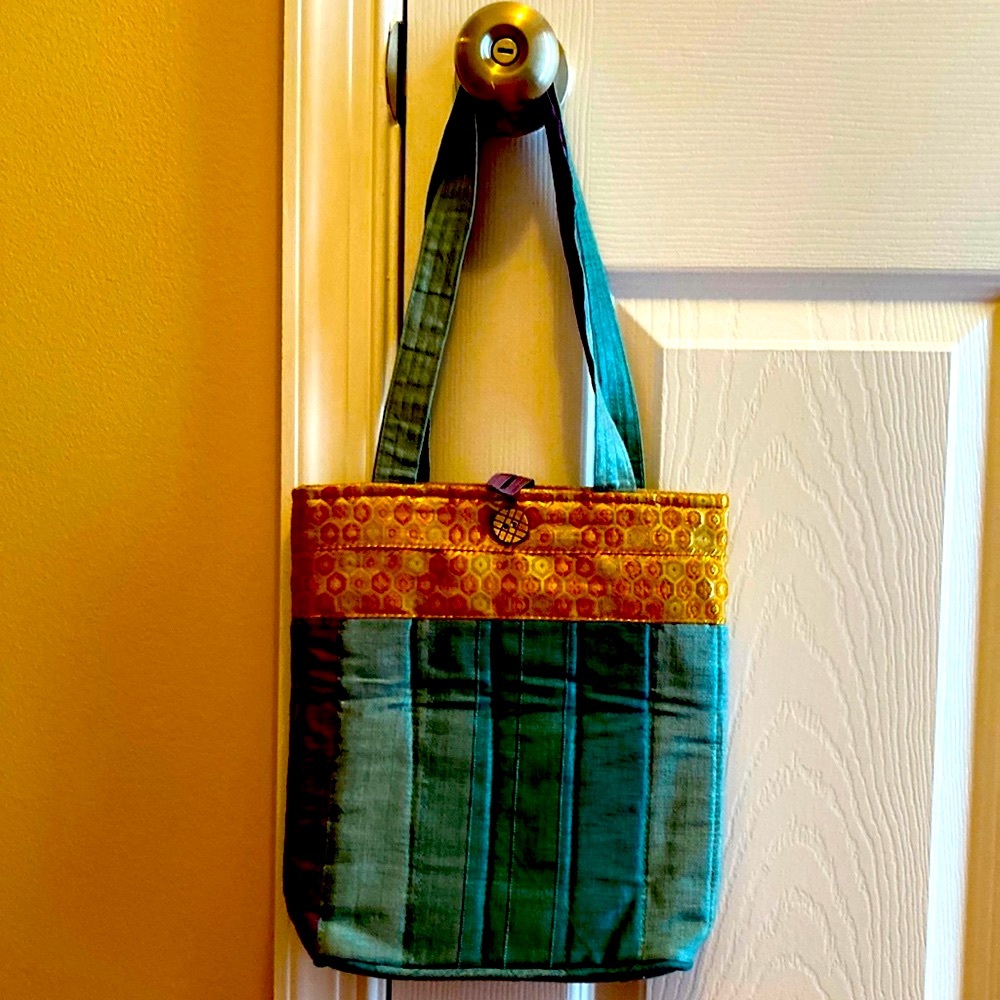 NWOT beautiful cloth mixed pattern one button closure bag.